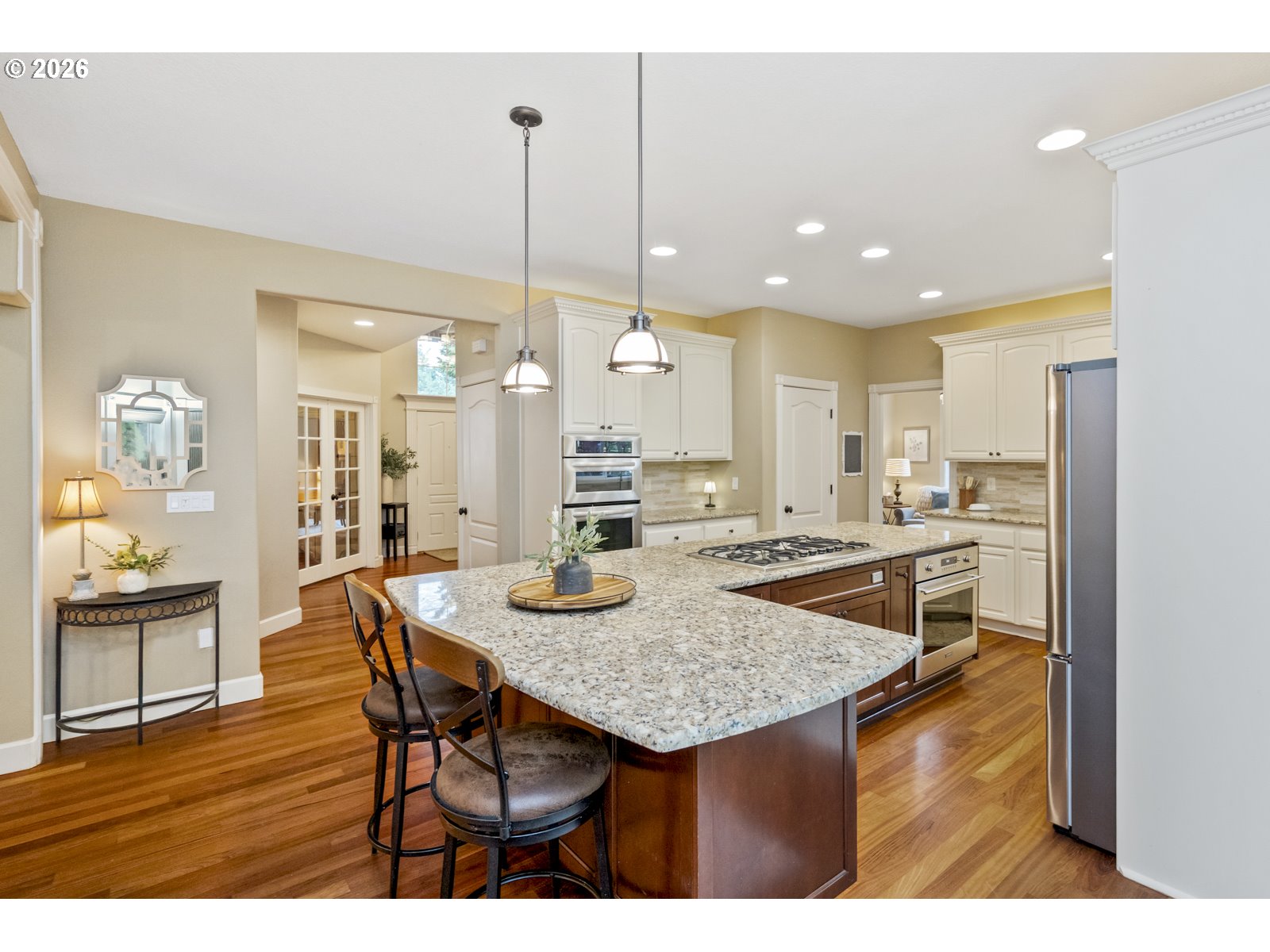 16520 Southwest Marcile Lane Beaverton, OR 97007 - Photo 12 of 45 a kitchen with a table chairs refrigerator and wooden floor