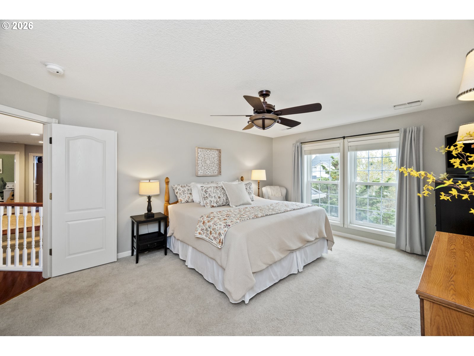 16520 Southwest Marcile Lane Beaverton, OR 97007 - Photo 25 of 45 a bedroom with a large bed and a chandelier