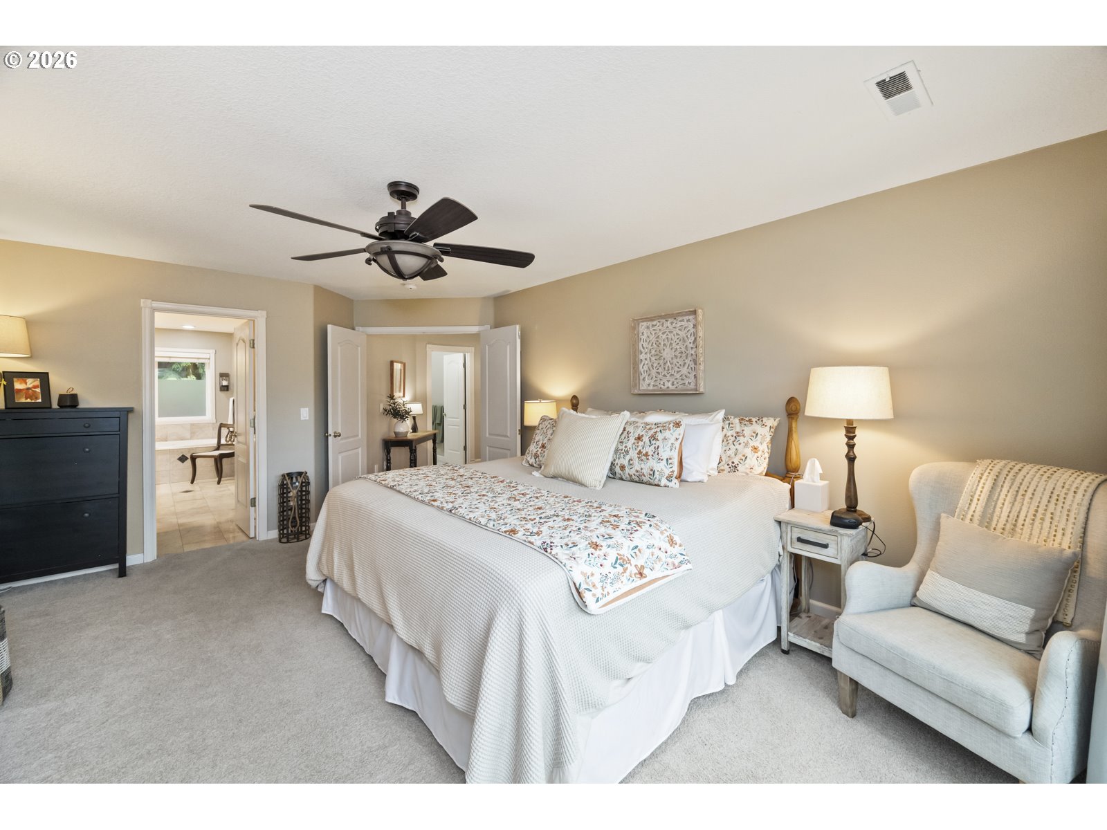 16520 Southwest Marcile Lane Beaverton, OR 97007 - Photo 26 of 45 a spacious bedroom with a bed and a chandelier