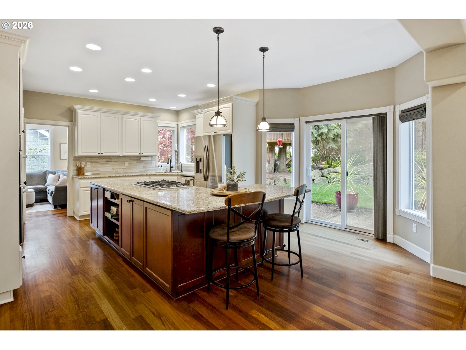 16520 Southwest Marcile Lane Beaverton, OR 97007 - Photo 6 of 45 a open kitchen with stainless steel appliances granite countertop a table chairs and a view of living room