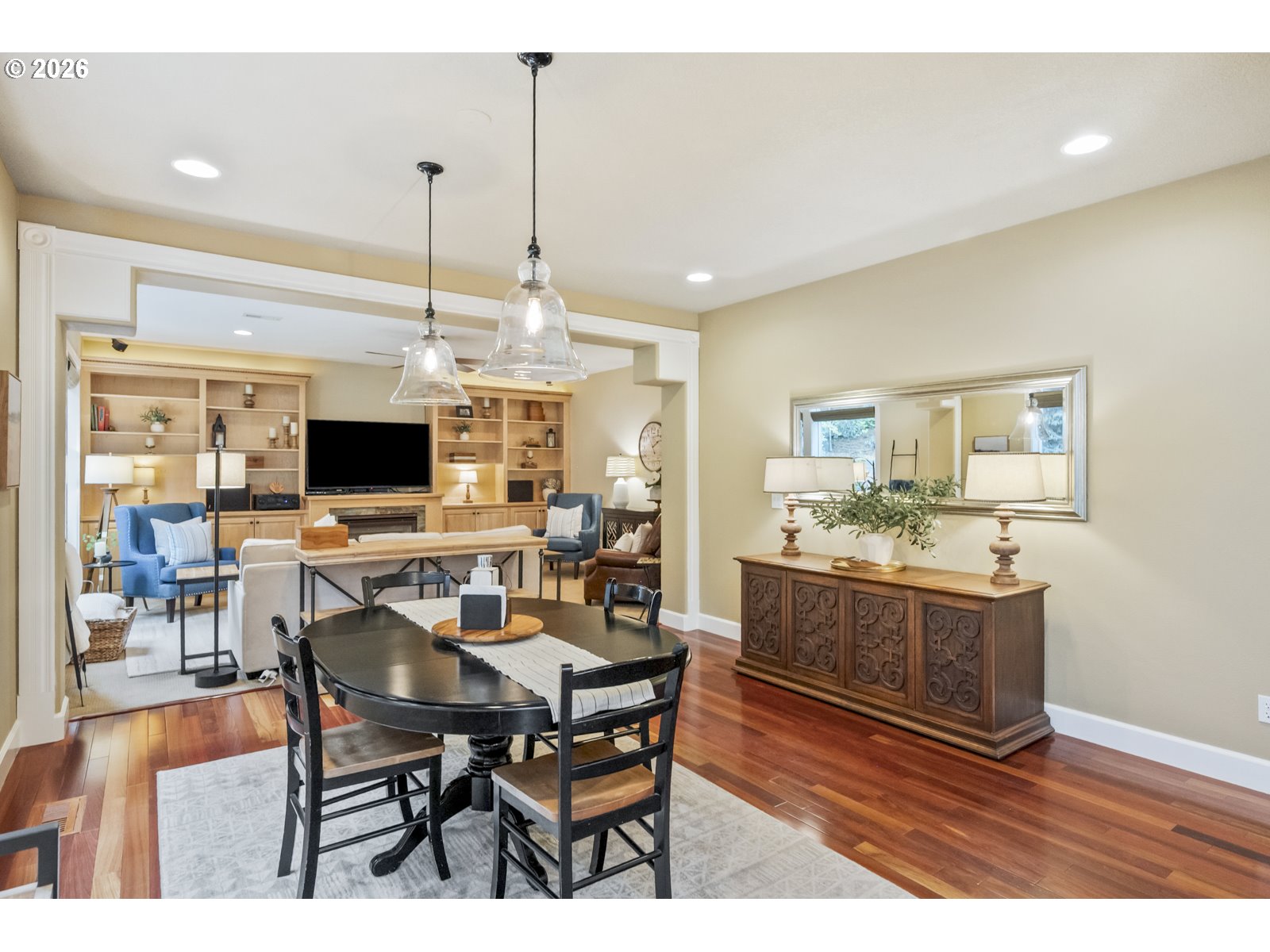 16520 Southwest Marcile Lane Beaverton, OR 97007 - Photo 10 of 45 a view of a dining room and livingroom with furniture wooden floor a rug a flat screen tv