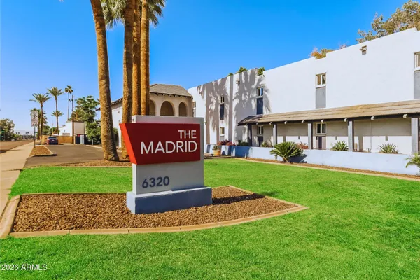 a view of a street with a building and a street sign