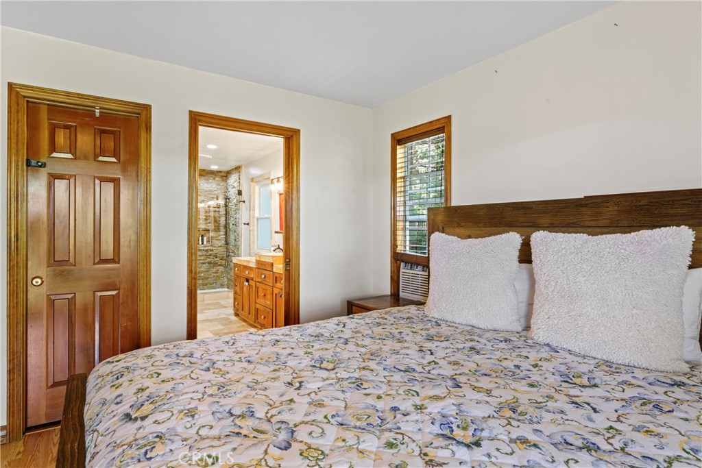 221 Grizzly Road Lake Arrowhead, CA 92352 - Photo 11 of 20 a bedroom with a bed and wooden floor