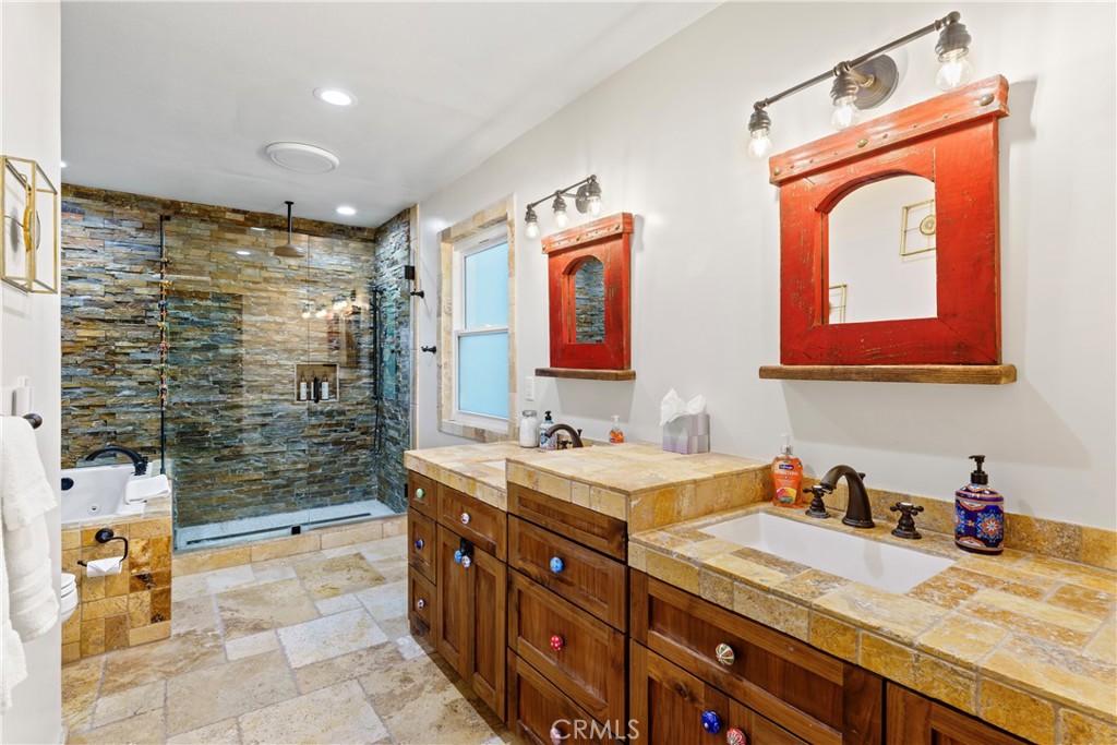 221 Grizzly Road Lake Arrowhead, CA 92352 - Photo 12 of 20 a bathroom with double vanity sinks a mirror and a shower