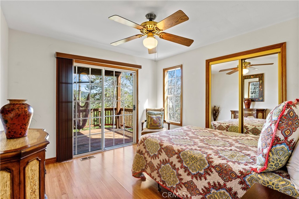 221 Grizzly Road Lake Arrowhead, CA 92352 - Photo 14 of 20 a bedroom with a bed and glass walk in closet