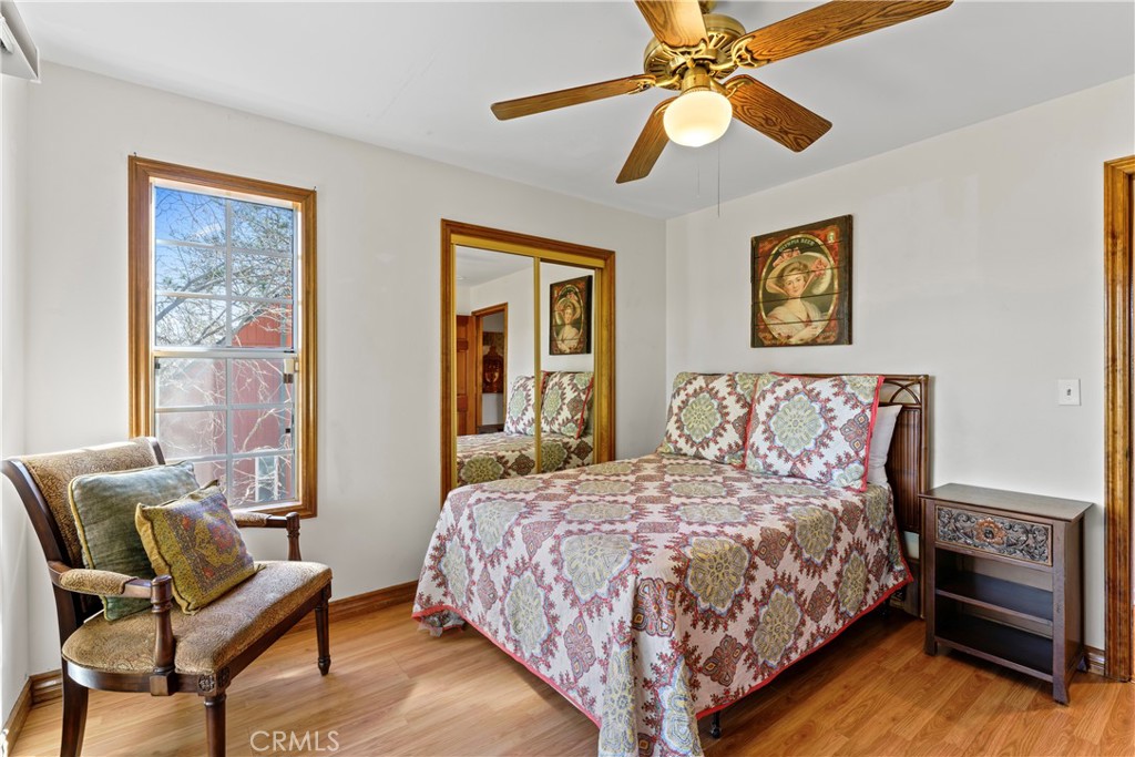 221 Grizzly Road Lake Arrowhead, CA 92352 - Photo 15 of 20 a bedroom with a bed and a chandelier