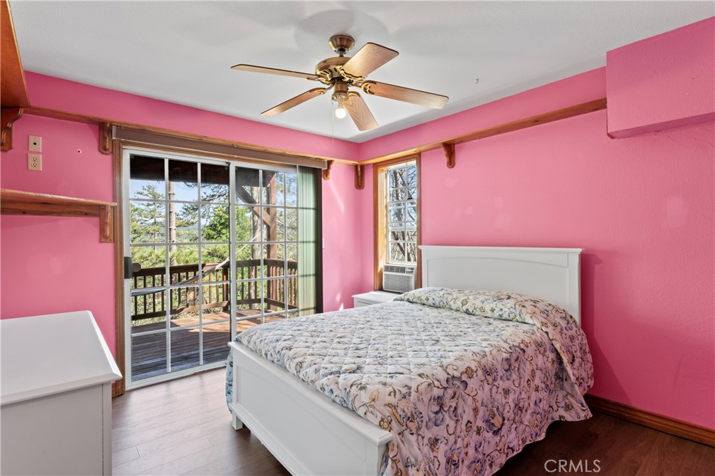 221 Grizzly Road Lake Arrowhead, CA 92352 - Photo 18 of 20 a bed room with a bed and a large window