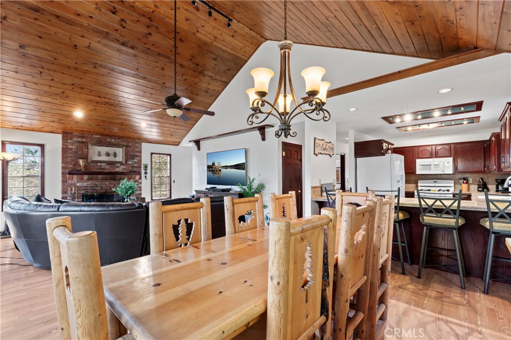 221 Grizzly Road Lake Arrowhead, CA 92352 - Photo 4 of 20 a view of a dining room with furniture a kitchen and chandelier