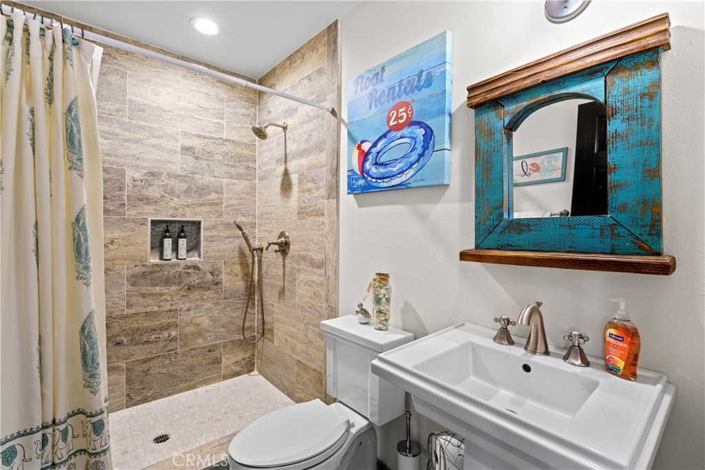 221 Grizzly Road Lake Arrowhead, CA 92352 - Photo 10 of 20 a bathroom with a toilet sink and mirror