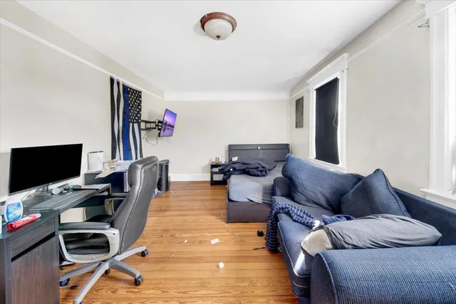 a living room with furniture a flat screen tv and a flat screen tv
