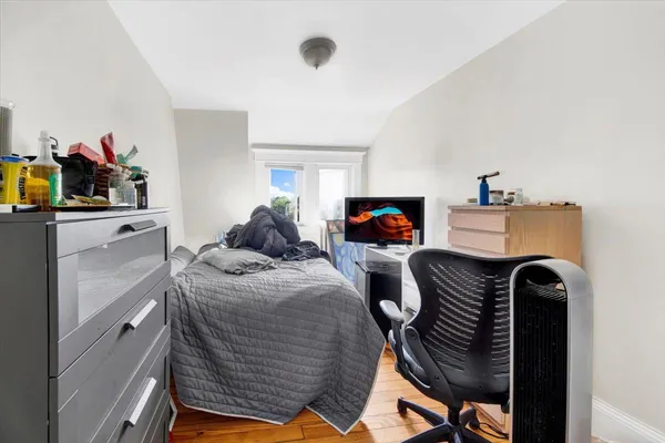 a bedroom with furniture and a flat screen tv