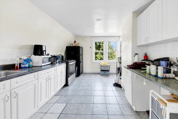 a kitchen with a sink cabinets and appliances