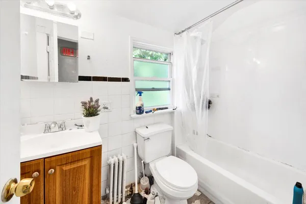 a bathroom with a sink toilet tub and shower