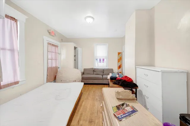 a bedroom with furniture and a book shelf