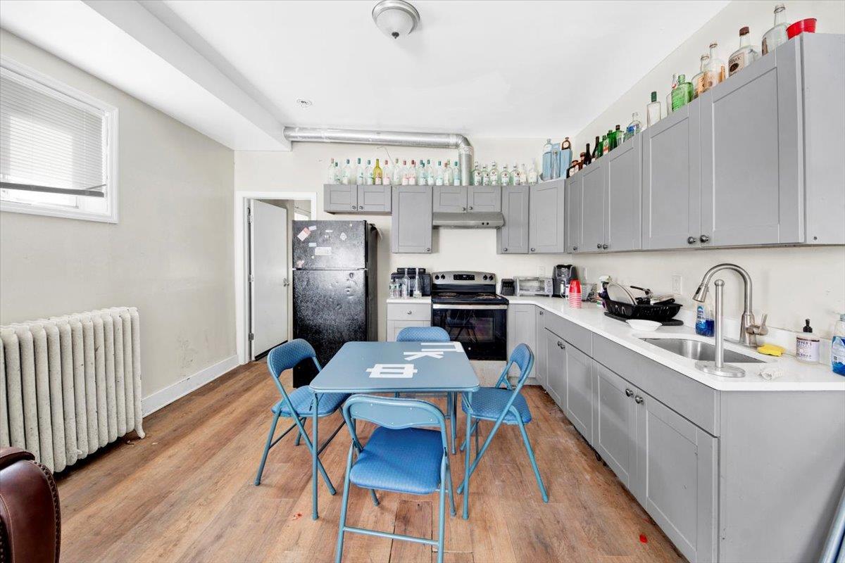 308 5th Avenue New Rochelle, NY 10801 - Photo 5 of 37 a kitchen with stainless steel appliances granite countertop a refrigerator a sink dishwasher a stove and white countertops with wooden floor