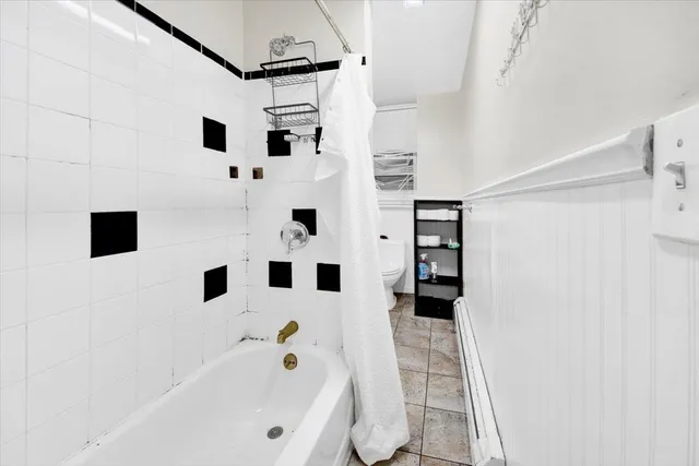 a bathroom with a bathtub and a shower