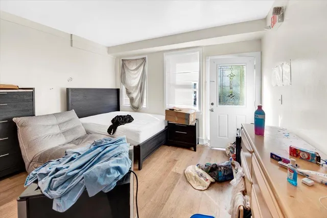 a bedroom with furniture and a flat screen tv