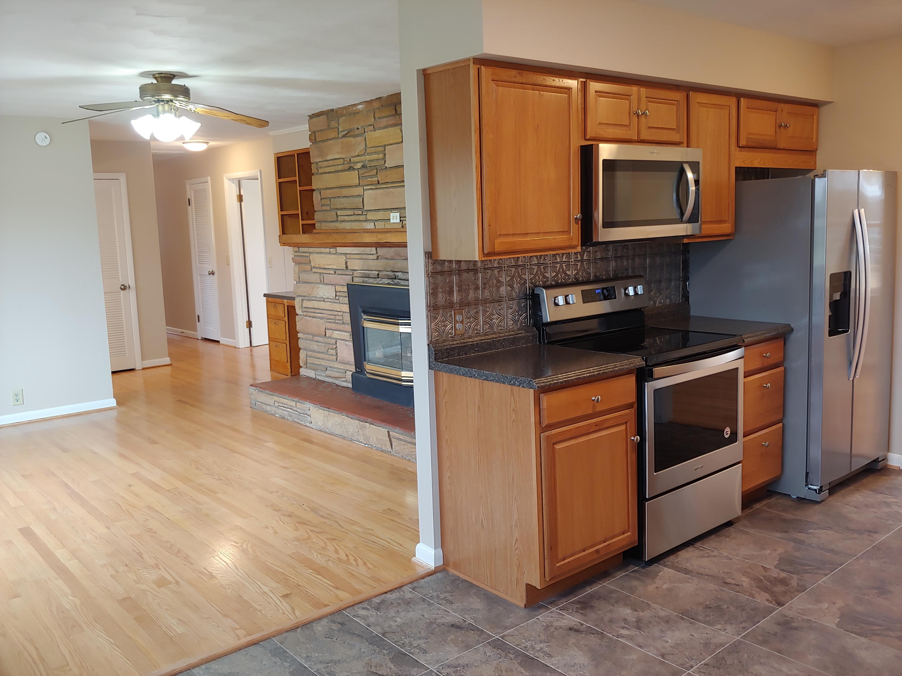 706 Alum Ridge Road Northwest Willis, VA 24380 - Photo 11 of 56 a kitchen with stainless steel appliances granite countertop a stove microwave and refrigerator