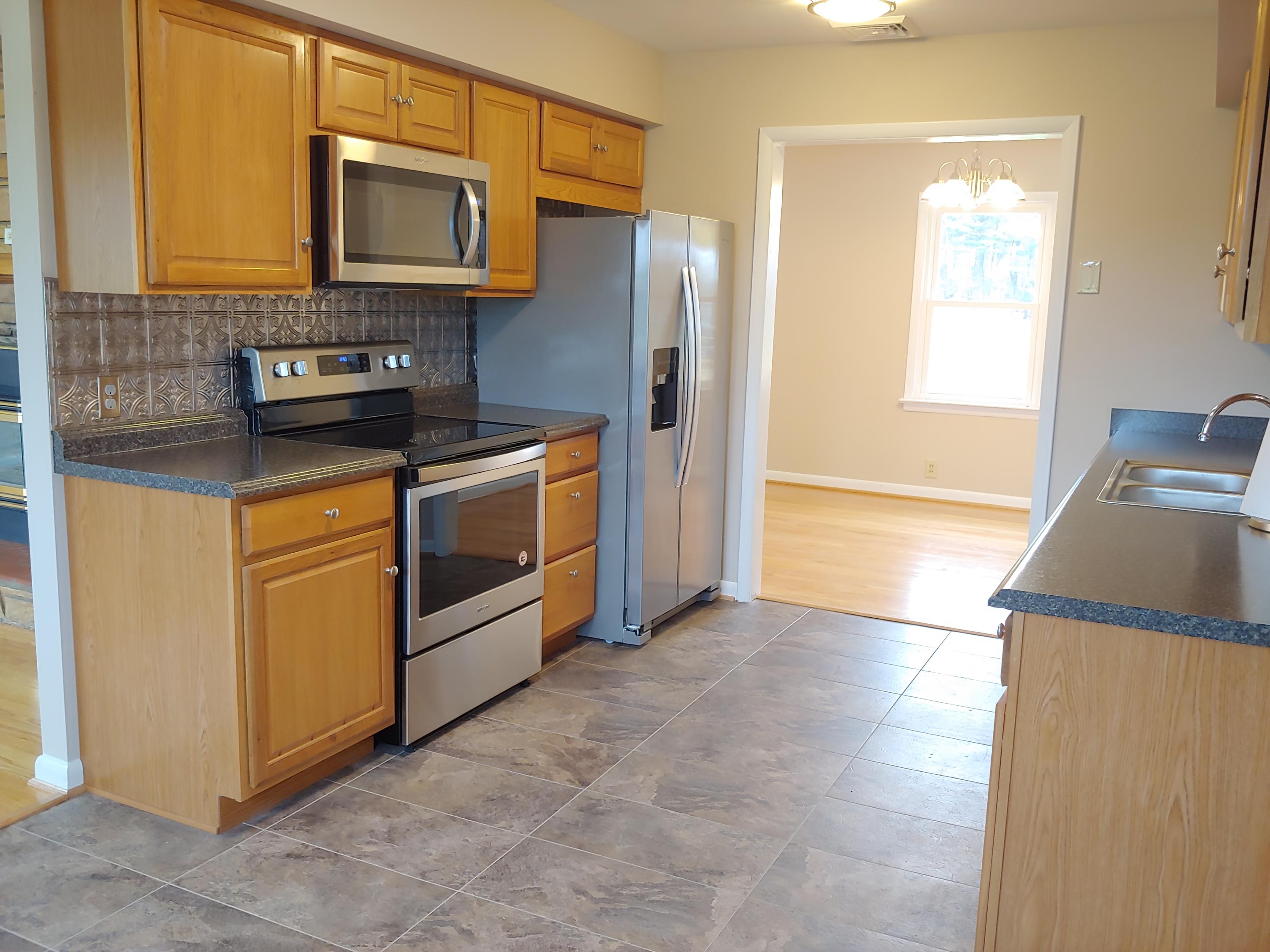 706 Alum Ridge Road Northwest Willis, VA 24380 - Photo 17 of 56 a kitchen with a stove microwave and sink