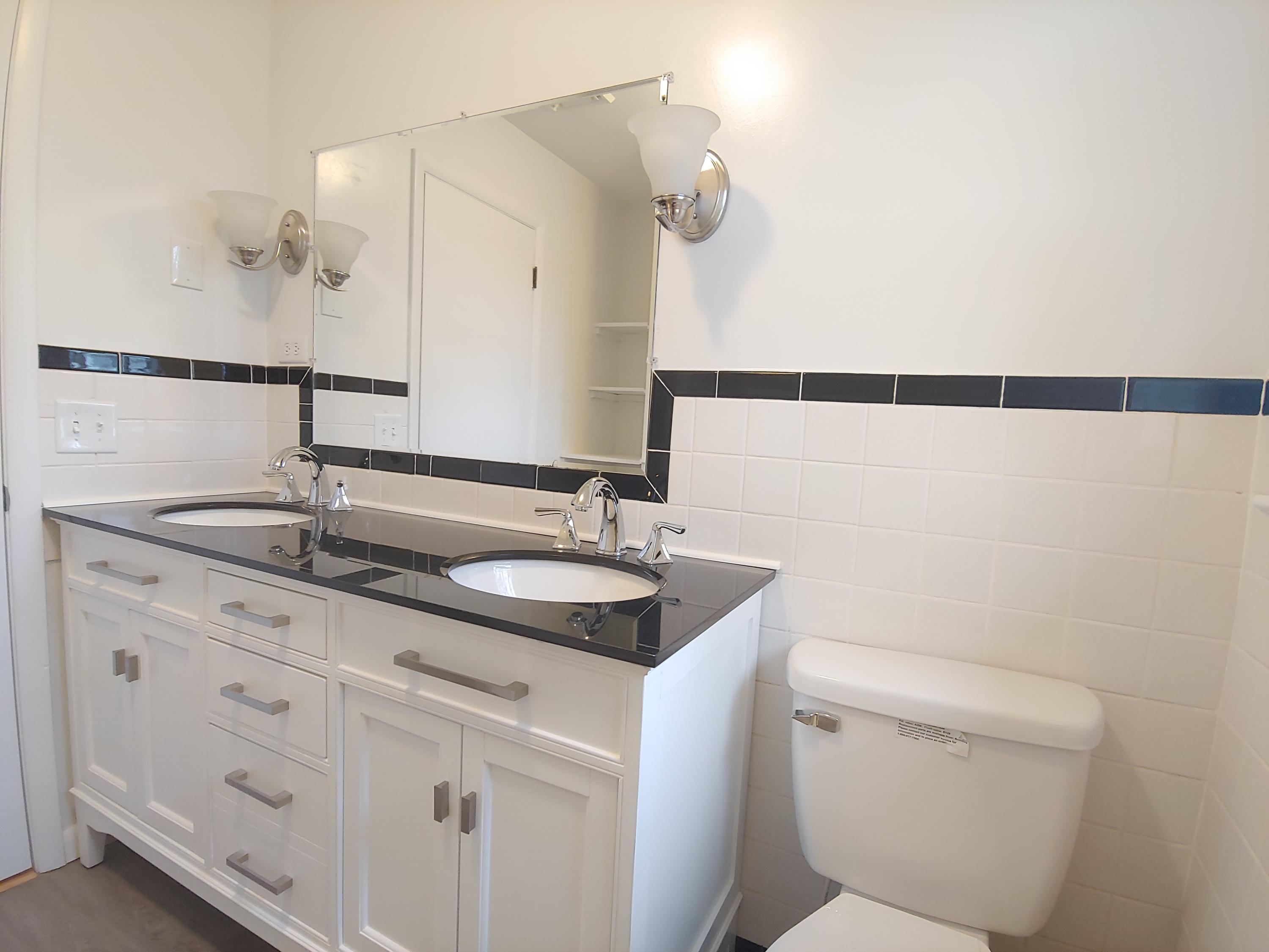 706 Alum Ridge Road Northwest Willis, VA 24380 - Photo 24 of 56 a bathroom with a sink and mirror with toilet