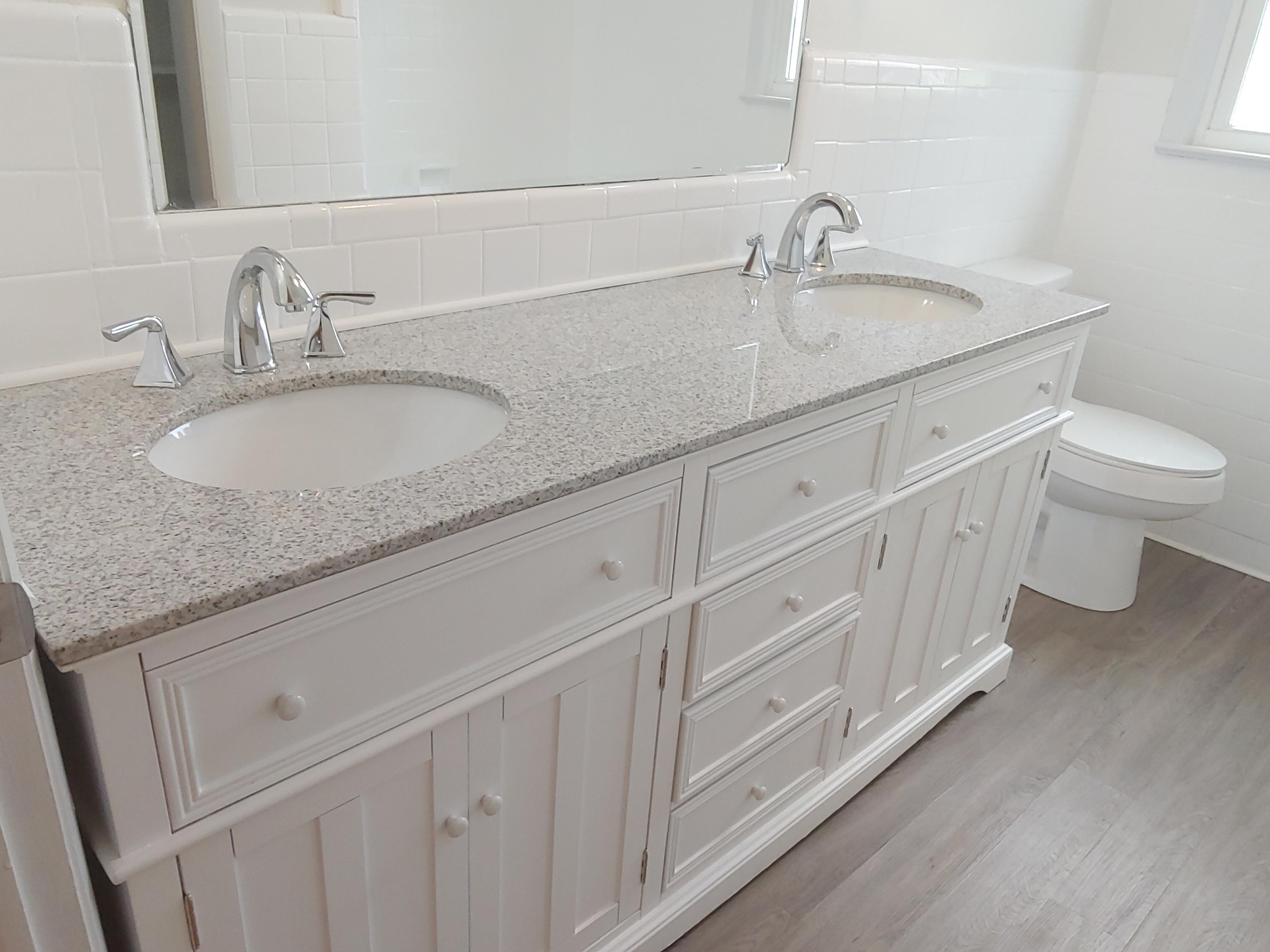 706 Alum Ridge Road Northwest Willis, VA 24380 - Photo 30 of 56 a bathroom with a granite countertop sink a toilet and a mirror
