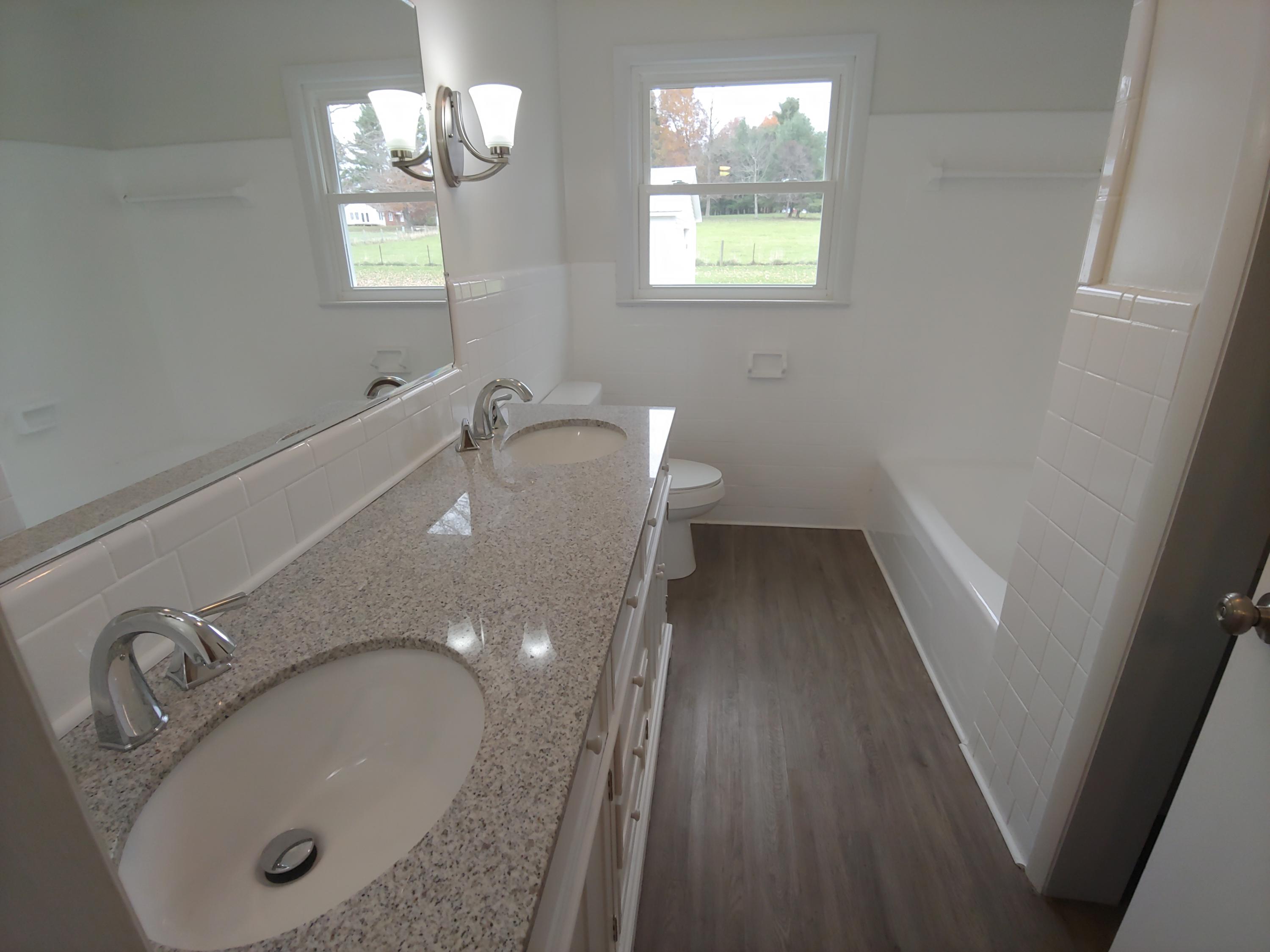 706 Alum Ridge Road Northwest Willis, VA 24380 - Photo 31 of 56 a bathroom with a sink a toilet and mirror