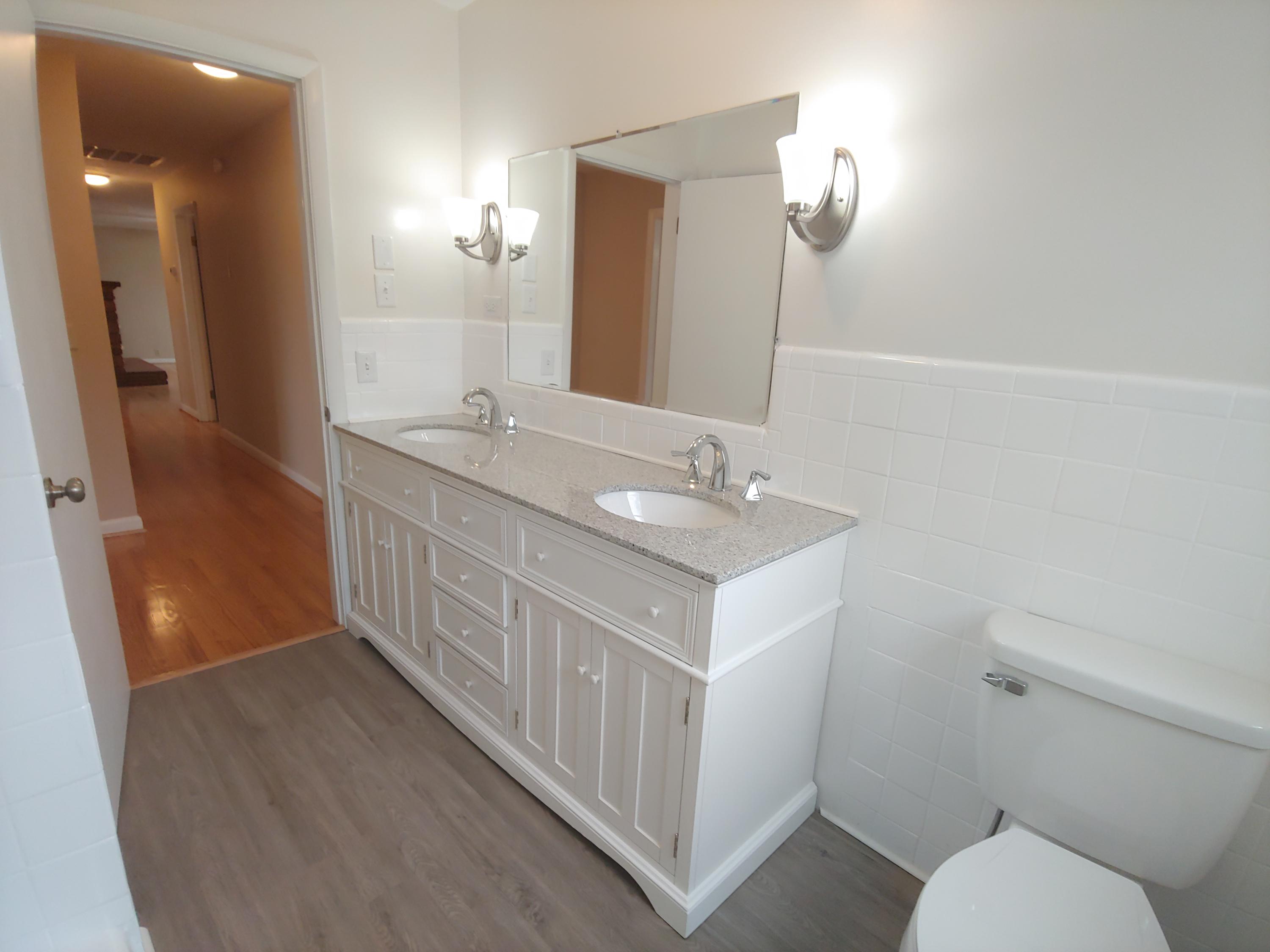 706 Alum Ridge Road Northwest Willis, VA 24380 - Photo 34 of 56 a bathroom with a double vanity sink toilet and mirror
