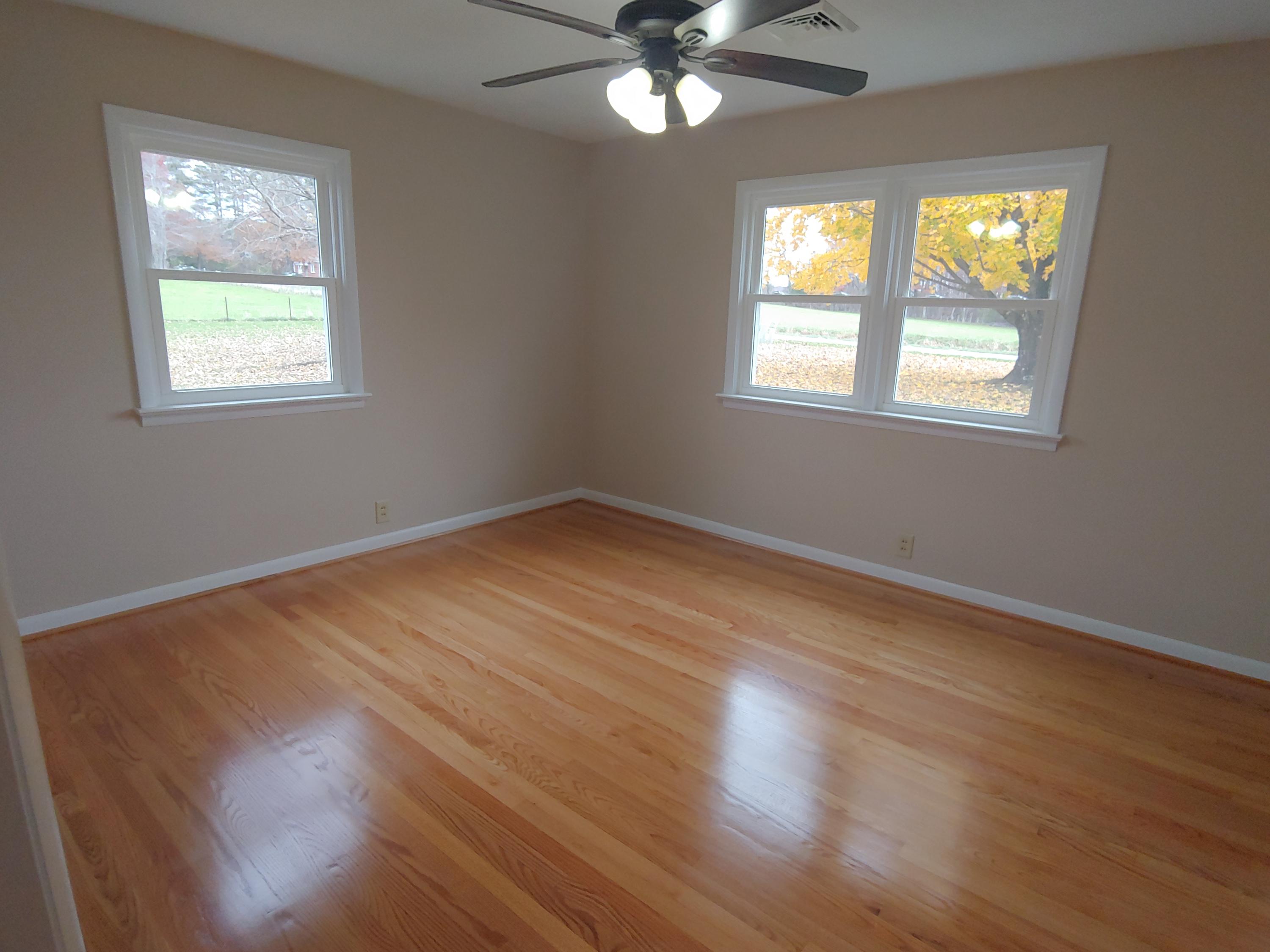 706 Alum Ridge Road Northwest Willis, VA 24380 - Photo 36 of 56 a view of an empty room with wooden floor and a window