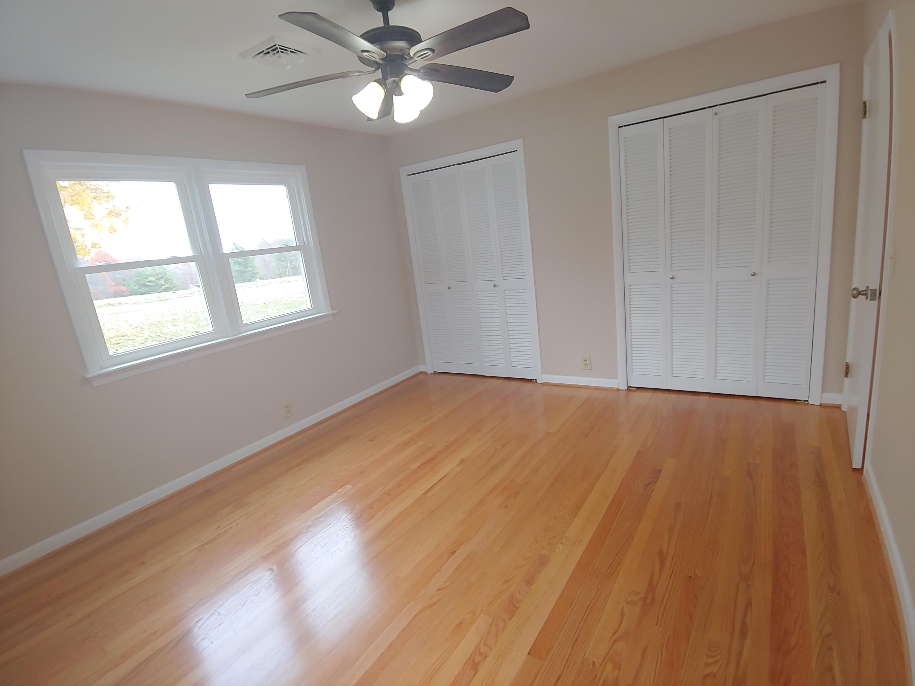 706 Alum Ridge Road Northwest Willis, VA 24380 - Photo 38 of 56 a view of empty room with wooden floor and fan
