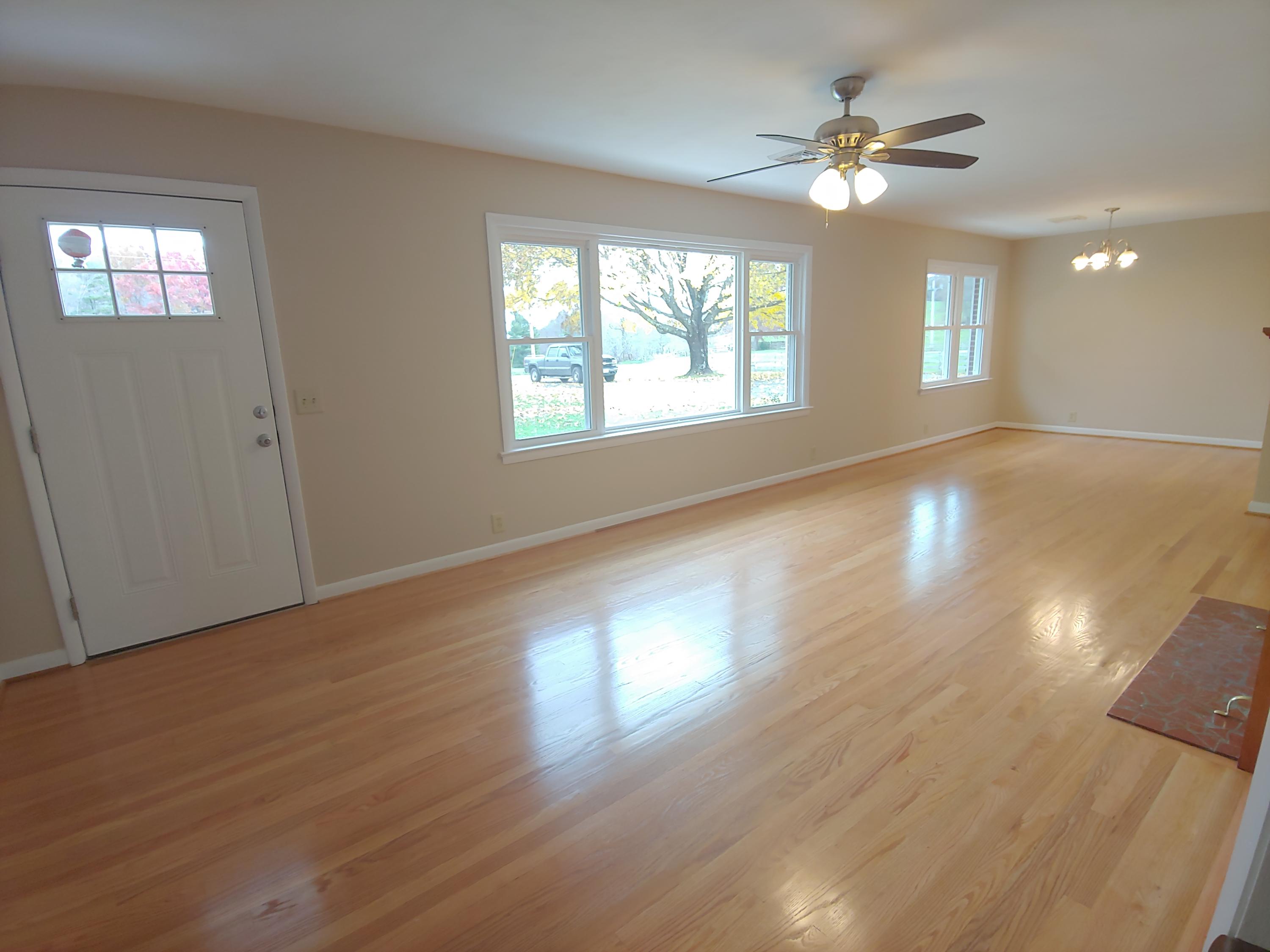 706 Alum Ridge Road Northwest Willis, VA 24380 - Photo 39 of 56 a view of an empty room with wooden floor and a window