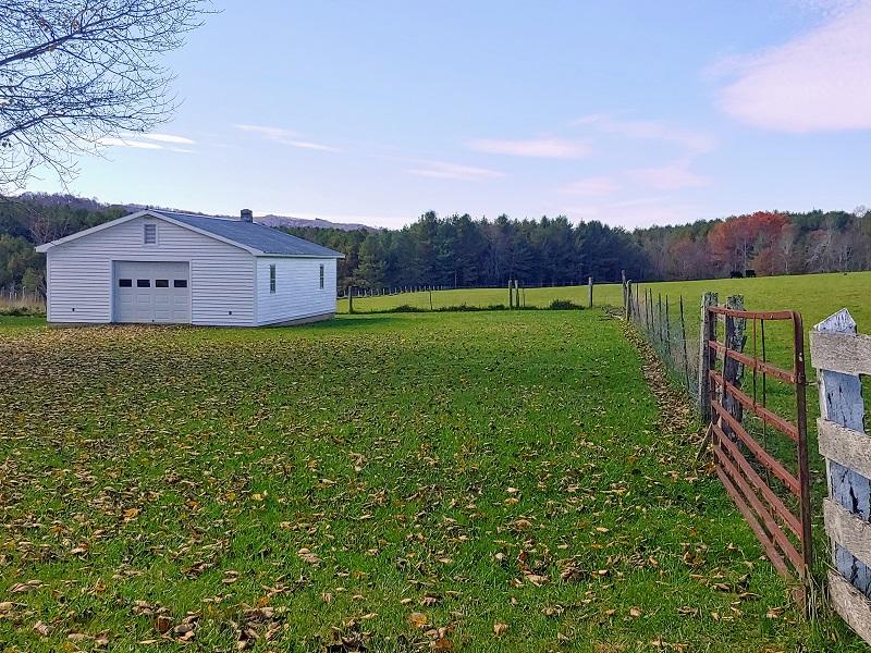 706 Alum Ridge Road Northwest Willis, VA 24380 - Photo 50 of 56 a view of a big house with a big yard and large trees