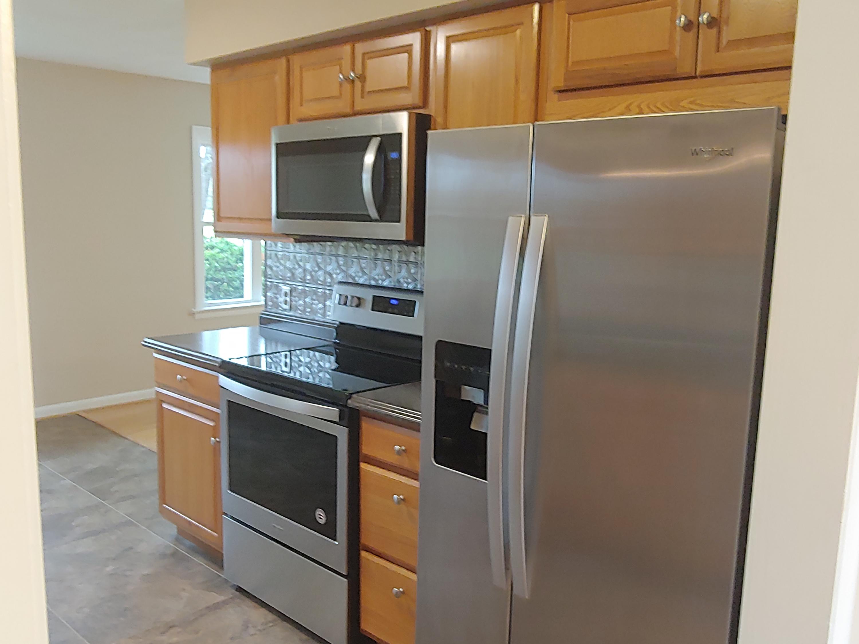 706 Alum Ridge Road Northwest Willis, VA 24380 - Photo 9 of 56 a kitchen with granite countertop cabinets and steel stainless steel appliances