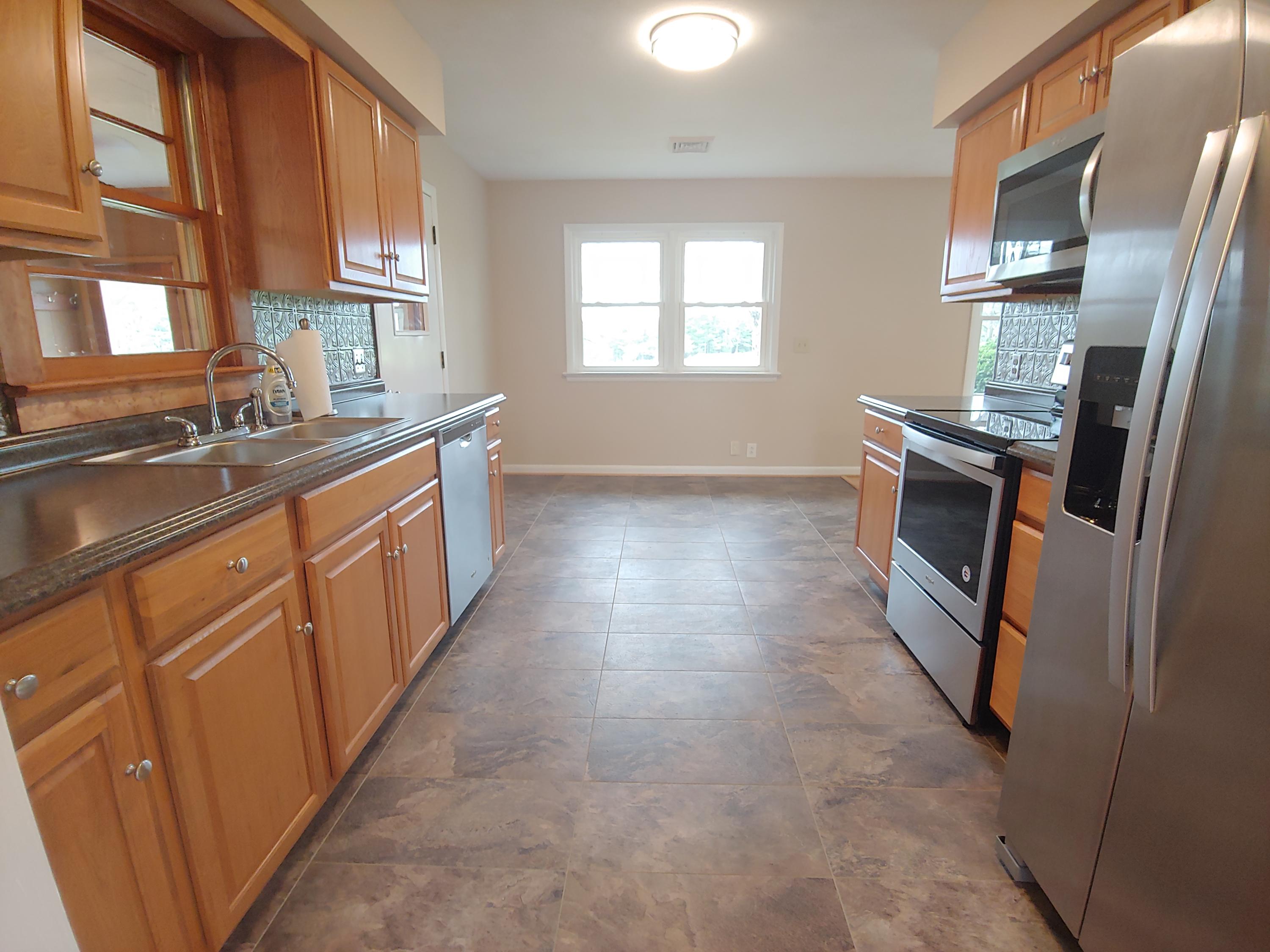 706 Alum Ridge Road Northwest Willis, VA 24380 - Photo 10 of 56 a kitchen with stainless steel appliances granite countertop a refrigerator a stove a sink and a microwave