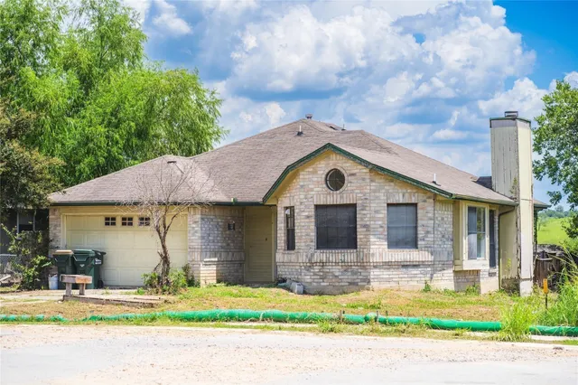 a front view of a house with a yard garage and outdoor seating