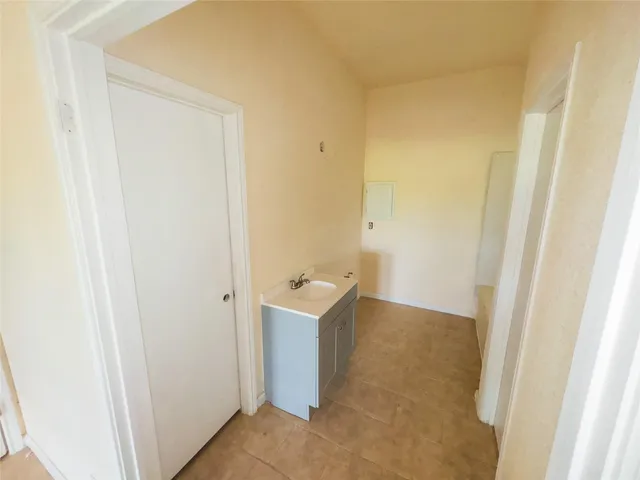 an empty room with a ceiling fan and a window
