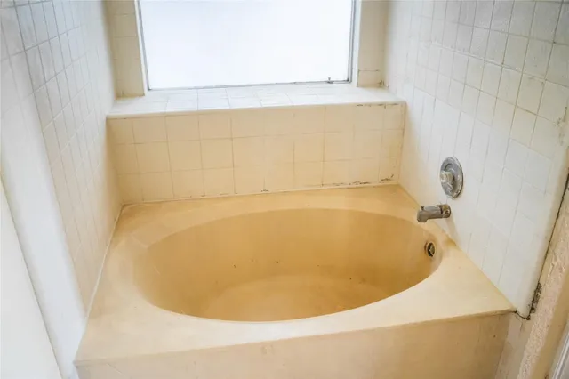 a bathroom with a tub and sink