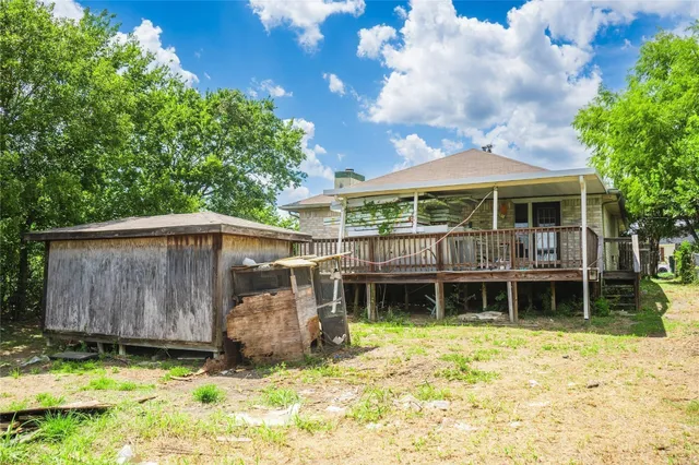a view of a backyard with wooden fence