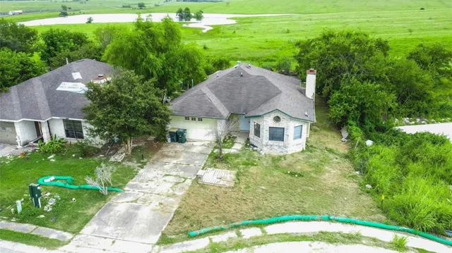 a aerial view of a house with a yard table and chairs