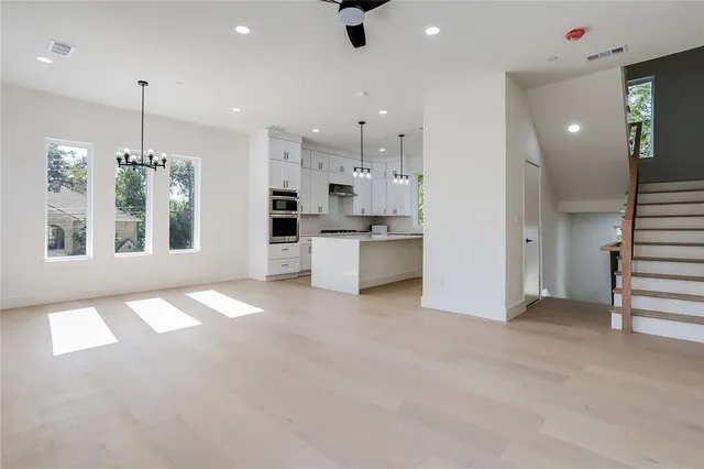 a view of a kitchen with refrigerator and windows