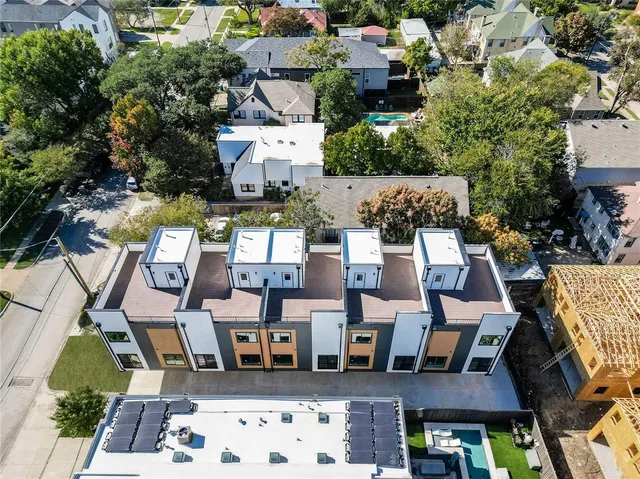 an aerial view of multiple houses with yard