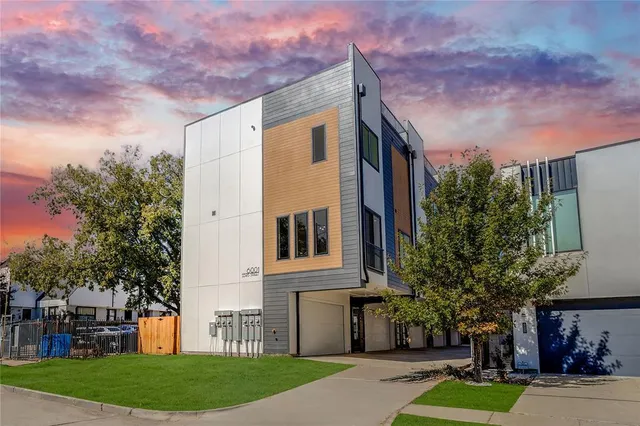 a front view of a house with a yard and a garage