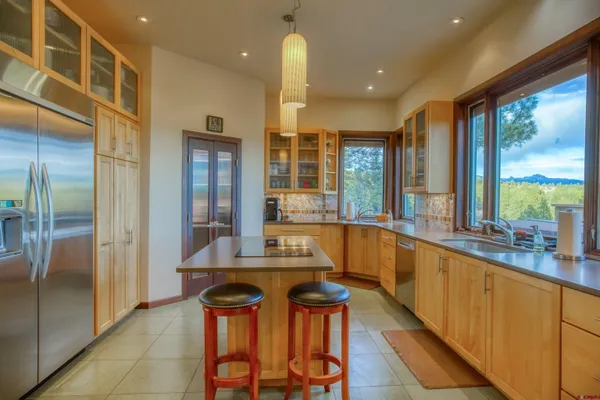 a large kitchen with a large window and stainless steel appliances