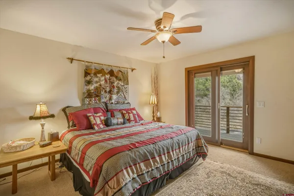 a bedroom with a bed next to a window with a bed