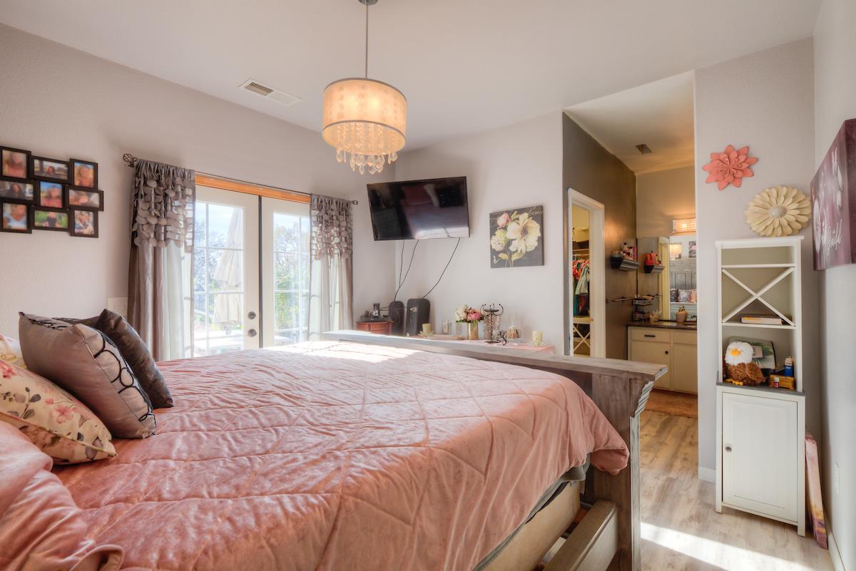 83 Northfork Road Berry Creek, CA 95916 - Photo 38 of 56 a bedroom with a large bed and a large window