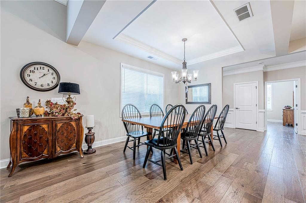 701 Calypso Way Cumming, GA 30040 - Photo 14 of 54 a view of a dining room with furniture window and wooden floor