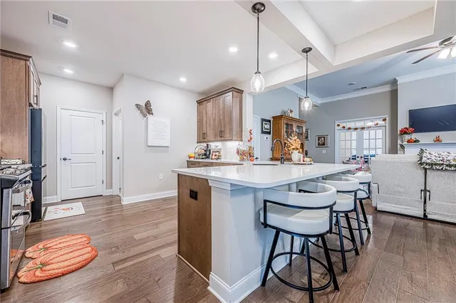 a kitchen with stainless steel appliances granite countertop a sink and a stove