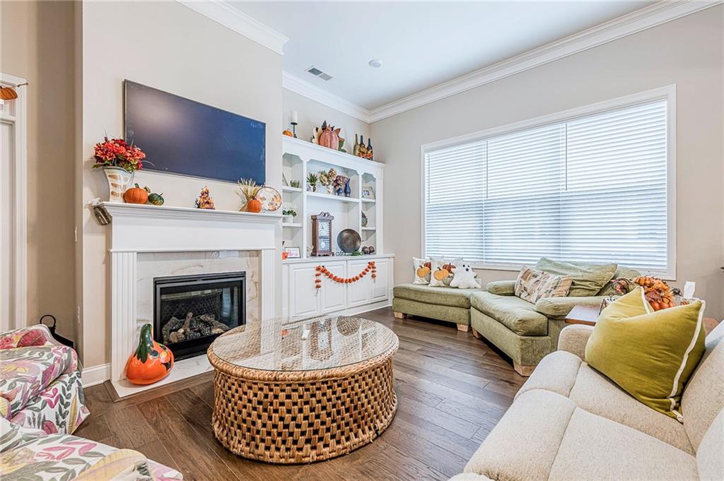 701 Calypso Way Cumming, GA 30040 - Photo 20 of 54 a living room with furniture and a fireplace