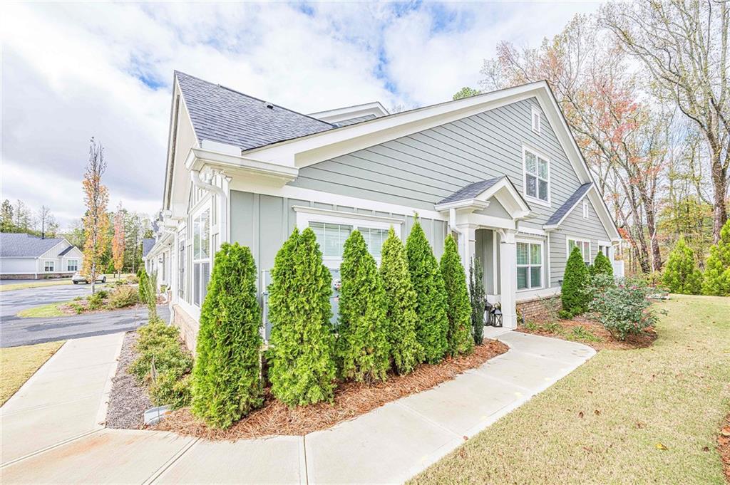 701 Calypso Way Cumming, GA 30040 - Photo 3 of 54 a front view of a house with garden