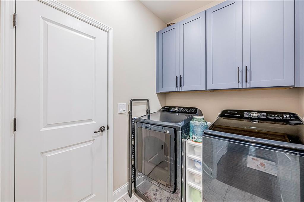 701 Calypso Way Cumming, GA 30040 - Photo 31 of 54 a kitchen with a stove and white cabinets