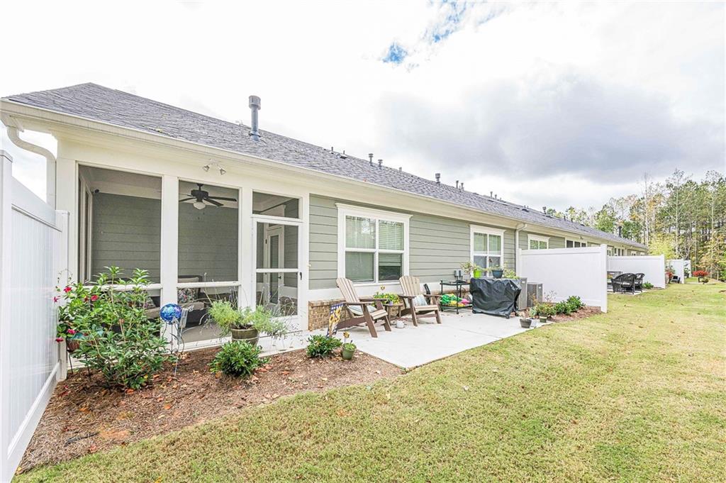 701 Calypso Way Cumming, GA 30040 - Photo 41 of 54 a front view of a house with swimming pool and outdoor seating